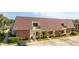 Two-story building with brown metal roof and brick facade. Ample parking is available at 2920 Pecan Ave, Leesburg, FL 34748