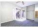 Bright bedroom with sliding glass doors to balcony and mirrored closet at 2920 Pecan Ave, Leesburg, FL 34748