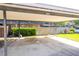 Covered carport with parking spaces next to a brick building at 2920 Pecan Ave, Leesburg, FL 34748
