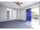 Bedroom with balcony access and ceiling fan at 2920 Pecan Ave, Leesburg, FL 34748