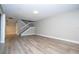 Living room with light gray walls, wood-look flooring, and a staircase at 2920 Pecan Ave, Leesburg, FL 34748