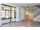 Bright living room featuring sliding glass doors and a modern staircase at 2920 Pecan Ave, Leesburg, FL 34748