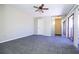 Bright bedroom with ceiling fan, gray carpet, and sliding glass doors at 2920 Pecan Ave, Leesburg, FL 34748