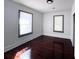 Well-lit bedroom with hardwood floors and dark-framed windows at 1414 Johns Ave, Haines City, FL 33844