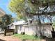 Home's exterior features a large tree and a fenced backyard at 1414 Johns Ave, Haines City, FL 33844