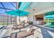 Covered patio furniture with view of pool and home interior at 4289 Lana Ave, Davenport, FL 33897
