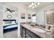 Bathroom with granite countertop, double sinks, and view of bedroom at 4289 Lana Ave, Davenport, FL 33897