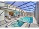 Resort-style pool and spa with covered patio and lounge chairs at 4289 Lana Ave, Davenport, FL 33897