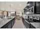 Modern kitchen with granite countertops and stainless steel appliances at 4289 Lana Ave, Davenport, FL 33897