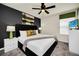 King-size bed, dark accent wall, and ceiling fan in this bedroom at 4289 Lana Ave, Davenport, FL 33897