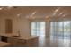 Open concept kitchen and living area with tile flooring and sliding doors at 204 Barrington Dr, Haines City, FL 33844