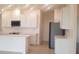 Bright kitchen with white cabinets, stainless steel appliances, and an island at 204 Barrington Dr, Haines City, FL 33844