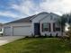 Newly built home with a three-car garage and red shutters at 204 Barrington Dr, Haines City, FL 33844