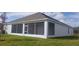 Home with a large screened patio and grassy backyard at 204 Barrington Dr, Haines City, FL 33844