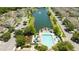 Aerial view showing a community pool, playground, and lake at 2208 San Vittorino Cir # 101, Kissimmee, FL 34741