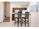 Efficient kitchen with dark wood cabinets, granite counters, and breakfast bar at 2208 San Vittorino Cir # 101, Kissimmee, FL 34741