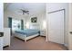Spacious bedroom with king-size bed, ample closet space, and window at 2208 San Vittorino Cir # 101, Kissimmee, FL 34741