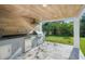Outdoor kitchen with grill, sink, and fridge at 104 E 1St Ave, Windermere, FL 34786