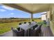 Covered patio with table and chairs, overlooking the backyard at 5692 Camilla St, St Cloud, FL 34771