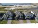 Aerial view of five new homes with gray roofs and brick driveways at 5692 Camilla St, St Cloud, FL 34771