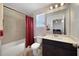 Clean bathroom with tub, shower, and dark vanity at 5692 Camilla St, St Cloud, FL 34771