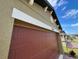 Attached garage with a brown door at 5692 Camilla St, St Cloud, FL 34771