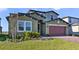 Two-story house with landscaping and two-car garage at 5692 Camilla St, St Cloud, FL 34771