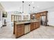 Open concept kitchen with island, stainless steel appliances, and Gathering room view at 310 Vista Oak Dr, Longwood, FL 32779