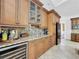 Wet bar with granite countertops, wine cooler, and custom cabinetry at 310 Vista Oak Dr, Longwood, FL 32779