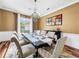 Formal dining room with hardwood floors, chandelier, and large windows at 310 Vista Oak Dr, Longwood, FL 32779