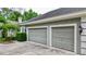Two-car garage with gray doors at 310 Vista Oak Dr, Longwood, FL 32779