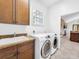 Bright laundry room with built in cabinets and access to other rooms at 310 Vista Oak Dr, Longwood, FL 32779