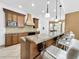 Kitchen island with seating and granite countertops, perfect for entertaining at 310 Vista Oak Dr, Longwood, FL 32779