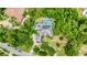 Aerial view of house, pool, and lush landscaping at 310 Vista Oak Dr, Longwood, FL 32779