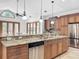 Kitchen island with granite countertop, stainless steel dishwasher, and custom cabinetry at 310 Vista Oak Dr, Longwood, FL 32779