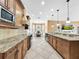 Large kitchen with granite countertops, wooden cabinets, and island at 310 Vista Oak Dr, Longwood, FL 32779