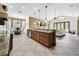 Open concept kitchen with island, granite countertops, and views into the Gathering room at 310 Vista Oak Dr, Longwood, FL 32779