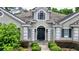 Front entrance of a home with a gray exterior and black door at 310 Vista Oak Dr, Longwood, FL 32779