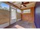 Cozy screened porch with wood flooring and ceiling fan at 1604 Peach Ave, Sanford, FL 32771