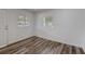 Simple spare bedroom with wood-look flooring and two windows at 1604 Peach Ave, Sanford, FL 32771