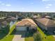 One-story house with a brown tile roof, in a community of similar homes at 196 Aidans Lndg, Haines City, FL 33844