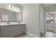 Modern bathroom with double vanity and an adjacent bedroom at 196 Aidans Lndg, Haines City, FL 33844