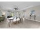 Bright dining area with a wood table and white chairs, open to the living room at 196 Aidans Lndg, Haines City, FL 33844