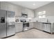 Modern kitchen featuring stainless steel appliances and light gray cabinetry at 196 Aidans Lndg, Haines City, FL 33844