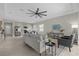 Open concept living room and kitchen with stainless steel appliances and neutral decor at 196 Aidans Lndg, Haines City, FL 33844