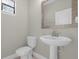 Clean powder room with pedestal sink and framed mirror at 196 Aidans Lndg, Haines City, FL 33844