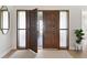 Elegant entryway with a large wood door and sidelights at 4041 Yacht Ct, Winter Park, FL 32792