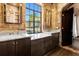 Double vanity bathroom with marble countertop and brick wall at 601 E Ridgewood St, Orlando, FL 32803