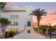 Elegant building with arched entryway and palm trees at sunset at 601 E Ridgewood St, Orlando, FL 32803