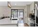 Modern kitchen features white cabinets, marble countertops, and stainless steel appliances at 4041 Yacht Ct, Winter Park, FL 32792